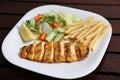 Grilled Chicken Breast with fries, lemon and slice served in a dish isolated on table side view of middle east food Royalty Free Stock Photo
