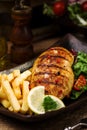 Grilled chicken breast with green salad and french fries Royalty Free Stock Photo
