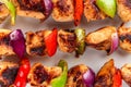Grilled chicken breast meat barbecue skewers with vegetables. Shish kebab or shashlik. top view. close up Royalty Free Stock Photo
