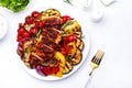 Grilled chicken breast and various vegetables. Colorful paprika, zucchini, eggplant, mushrooms, tomatoes, onion with rosemary on Royalty Free Stock Photo