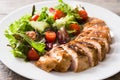 Grilled chicken breast with vegetables on a plate on wood Royalty Free Stock Photo