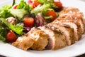 Grilled chicken breast with vegetables on a plate on wood Royalty Free Stock Photo