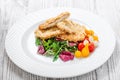 Grilled chicken breasts with sesame, salad with cabbage fat and rucola on light wooden background. Royalty Free Stock Photo