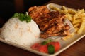 Grilled chicken breasts with thyme, garlic and lemon slices on a grill pan close up, top view Royalty Free Stock Photo