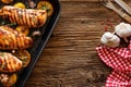 Grilled chicken breasts with thyme, garlic and lemon slices on a grill pan on a wooden background Royalty Free Stock Photo