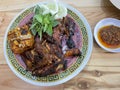 Grilled chicken with chili sauce and fresh vegetables on a classic oriental style round plate Royalty Free Stock Photo