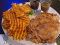 Grilled chicken chop served with salad, criss cut waffles fries, mushroom sauce and black pepper sauce