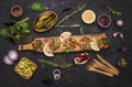 Grilled chicken cutlets or meatballs, grilled zucchini, pickled cucumbers and fresh herbs on rustic black wood background