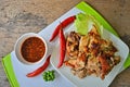 Grilled chicken dish with hot sauce dish on white block Royalty Free Stock Photo