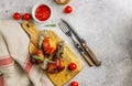 Grilled chicken drumstick bbq on a cutting board on a stone gray background Royalty Free Stock Photo