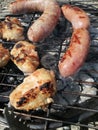 Grilled chicken drumsticks and sausages, barbecue party in nature,Garden Party Chicken leg on the grill Royalty Free Stock Photo