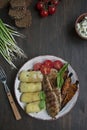 Grilled chicken fillet with baked vegetables. Wooden background. Space for text