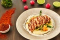 Grilled chicken fillet is cut into slices on a cushion of mashed potatoes with vegetables - onion, garlic, pepper, cabbage, radish Royalty Free Stock Photo
