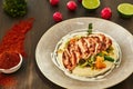 Grilled chicken fillet is cut into slices on a cushion of mashed potatoes with vegetables - onion, garlic, pepper, cabbage, radish Royalty Free Stock Photo