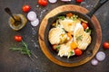 Grilled chicken fillet and various vegetables on a cast-iron frying pan. Royalty Free Stock Photo