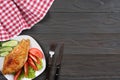 Grilled chicken fillet on white plate with tomato on dark wooden background with red cloth. With copy space. Top view Royalty Free Stock Photo