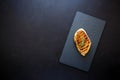 Grilled chicken fillets on slate plate with rosemary, pepper and spices on dark wooden background. Top view. Flat lay Royalty Free Stock Photo