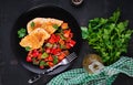 Grilled chicken fillets and sweet pepper on black plate. Royalty Free Stock Photo