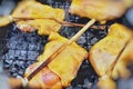 Grilled chicken four legs thigh on the flaming grill Royalty Free Stock Photo