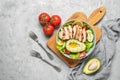 Grilled chicken with fresh vegetable salad on a gray concrete background. Healthy food concept. Top view, flat lay Royalty Free Stock Photo