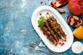 Grilled chicken hearts on skewers with pomegranate, lemon and ga