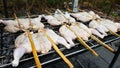 Grilled chicken with iron preparations on the iron grill smoke a lot, Food in thailand