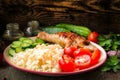 Grilled chicken leg, white rice, slised cucumber with sesame seeds, tomtoes and herbs.