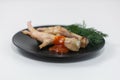 Grilled chicken legs on a black plate Royalty Free Stock Photo