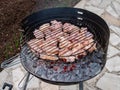 Grilled chicken legs on the flaming barbeque grill Royalty Free Stock Photo