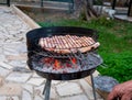 Grilled chicken legs on the flaming barbeque grill Royalty Free Stock Photo