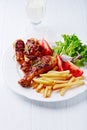 Grilled Chicken Legs with French Fries and Salad Royalty Free Stock Photo