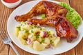 Grilled chicken legs with potato salad, vegetables and tomato sauce Royalty Free Stock Photo