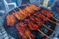 Grilled chicken meat with wooden stick at night street market, Thailand Royalty Free Stock Photo