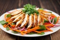 grilled chicken salad with carrot strips and radish slices