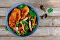 Grilled chicken salad with fresh vegetables on old wooden background