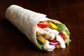 Grilled chicken and salad tortilla wrap with white sauce isolate Royalty Free Stock Photo