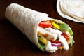 Grilled chicken and salad tortilla wrap with white sauce isolate Royalty Free Stock Photo