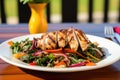 grilled chicken served over rainbow chard salad