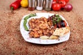 Grilled Chicken Serving on White Plate  and Salad with Fresh Vegetables on Spicy Wooden Table Royalty Free Stock Photo