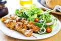 Grilled chicken skewer with salad