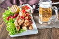 Grilled chicken skewers with mug of beer Royalty Free Stock Photo