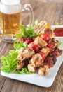 Grilled chicken skewers with mug of beer Royalty Free Stock Photo