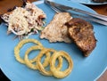 Grilled Chicken steak with salad and onion rings Royalty Free Stock Photo