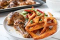 Grilled chicken with sweet potato fries and mediterranean salad on a plate Royalty Free Stock Photo