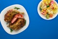 Grilled chicken thigh with vegetables on a white plate with vegetable salad on a colored background.fast food top view.junk food