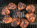 grilled bone-in chicken-thighs over glowing mesquite charcoal Royalty Free Stock Photo