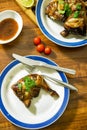 Grilled chicken thighs on white plate with wood table Royalty Free Stock Photo