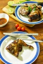 Grilled chicken thighs on white plate with wood table Royalty Free Stock Photo