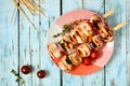 Grilled chicken and vegetable kabobs, top view over blue wood Royalty Free Stock Photo