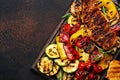 Grilled chicken and vegetables. Bbq party. Colorful paprika, zucchini, eggplant, mushrooms, tomatoes, onion and rosemary, served Royalty Free Stock Photo